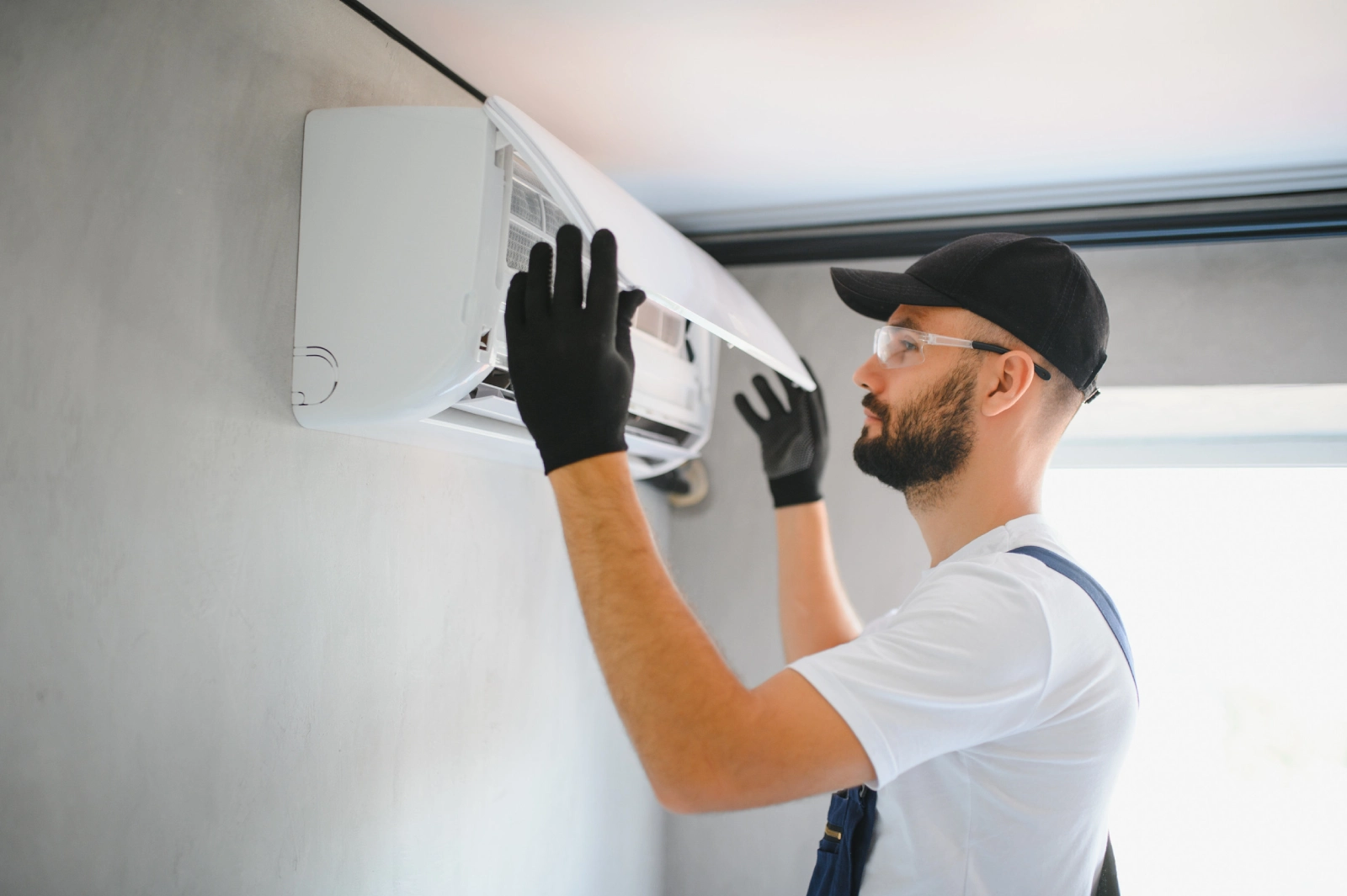 Male technicians service for repair and maintenance of air conditioners
